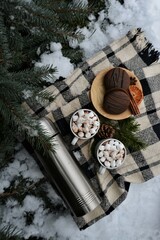Winter picnic in the forest. Picnic basket in the snow. Winter holidays	