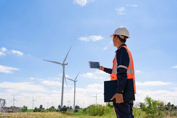 Engineer walk to check wind power plants with check performance. Wind turbines are an alternative electricity source to be sustainable resources in the future. Clean energy concept saves the world