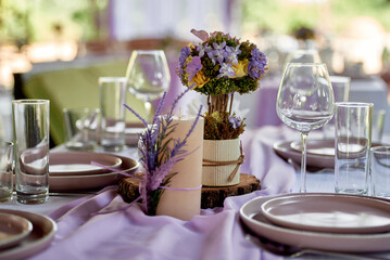 Beautiful floral arrangement and candles on wedding table in restaurant, copy space. Luxury wedding...