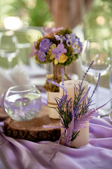 Beautiful floral arrangement and candles on wedding table in restaurant, copy space. Luxury wedding decorations