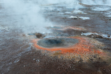 Chile, San Pedro de Atacama, Tatio Geysers. The geyser field contains many small colorful fumaroles...