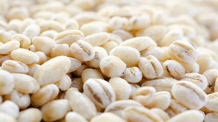Pearl barley background close-up, top view. Pearl barley closeup, grain texture, top view. Pearl barley is processed barley grains that have been processed.