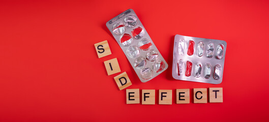 Words side effect on colored red paper texture background. Concept. Empty pill blister pack. Covid 19 illness therapy. Disease treatment side effect or toxicity. Copy space. Mock up design template