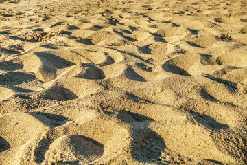Close-up view of the surface of a sandy beach after a day's rest of tourists