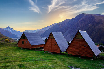 Fototapeta na wymiar Log cottages for a calm inspired relaxing holiday weekend in a mountain valley