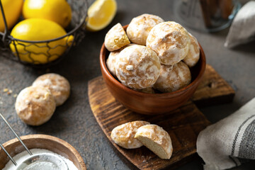 Lemon gingerbread in a wooden bowl on a dark culinary background. Delicious homemade cookies closeup	