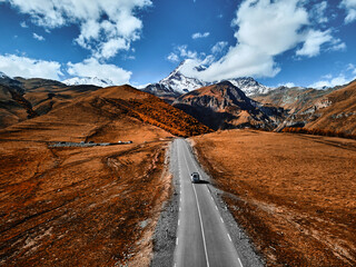 The road to the famous majestic Mount Kazbegi, the third highest peak in Georgia. Greater Caucasus....