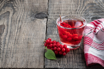 Schisandra tea in clear glass cup on wooden table