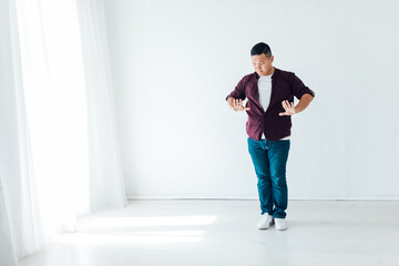 Asian man dancing to music alone at home