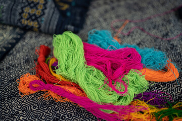 Balls of yarn for knitting. Balls of yarn for knitting in a wicker basket. A knitting yarn, knitted...