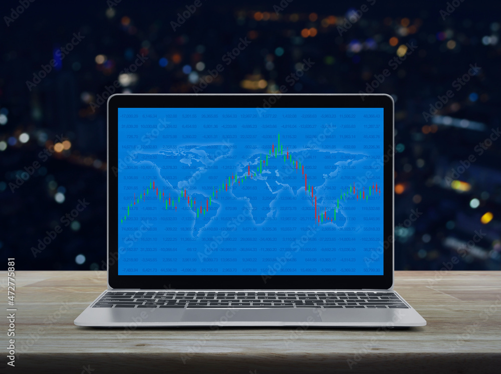 Poster trading graph of stock market with world map and graph on laptop computer on table over blur colorfu
