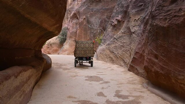 Horse carriage riding through the Siq Canyon to Al-khazneh (The Treasury), Petra, Jordan