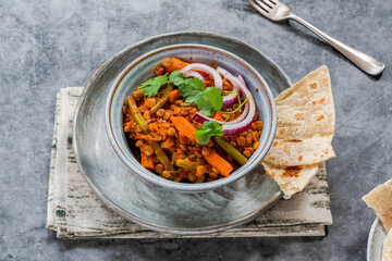 Vegan green lentil curry with paratha flatbread
