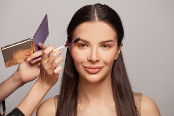 Obraz premium Attractive female fashion model getting ready for fashion show backstage, natural nude makeup