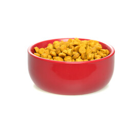 Dry food for dogs and cats in red bowl on white background