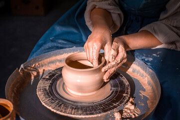 Young lady enjoying pottery art and production process. Artisan production. Close-up.