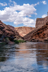 Fototapeta na wymiar USA, Arizona. Floating down the Colorado River with canyon walls and clouds, Grand Canyon National Park.
