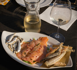 Fish appetizer platter on curly white plate