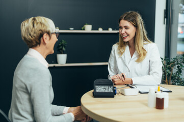 Naklejka premium Female doctor in consultation with a senior woman patient