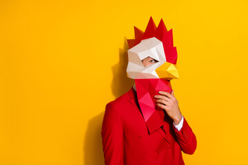 Photo of minded smart guy look empty space wear rooster polygonal mask red suit isolated yellow...