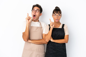 Restaurant mixed race waiters isolated on white background thinking an idea pointing the finger up