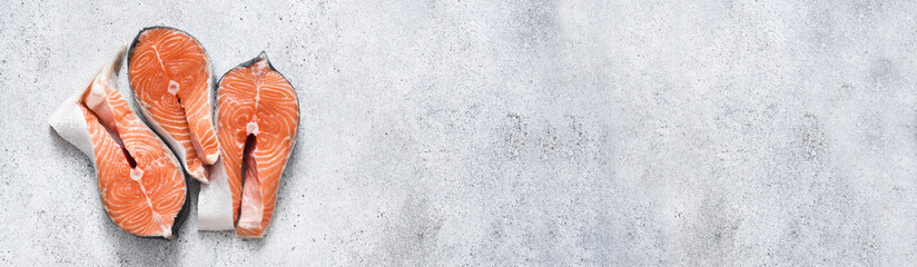 Salmon steak. Raw fresh red fish with spices on a concrete background.