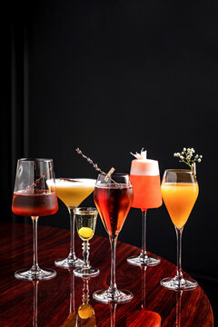 A selection of different low abv cocktails in beautiful glassware at a wooden table in a restaurant