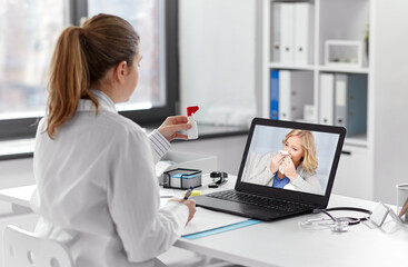 Fototapeta na wymiar healthcare, technology and medicine concept - female doctor with laptop computer having video call with middle aged patient and showing oral spray at hospital