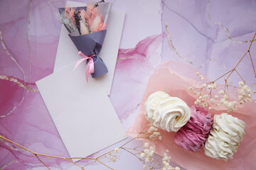 Delicate pink and white marshmallow with decoration of gypsophila and dryflowers bouquet. Mock up card. Feminine background, template. Cozy winter weekends. Homemade sweets