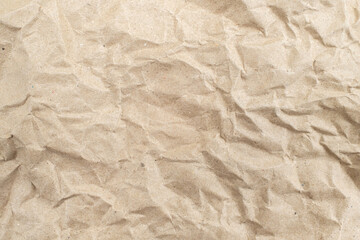 Recycled brown creased paper background from a paper packing. Crumpled brown paper texture concept
