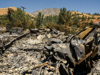 Remains of house after wildfire in Southern Sierra Nevada Mountains, from drought stressed forest