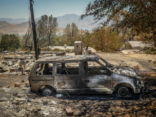 Fototapeta na wymiar Remains of house after wildfire in Southern Sierra Nevada Mountains, from drought stressed forest