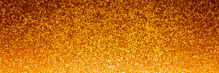 Holiday glowing backdrop. Defocused background with glitter. Blurred bokeh.