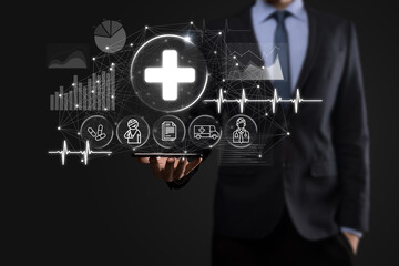 Businessman hold virtual plus medical network connection icons. Covid-19 pandemic develop people awareness and spread attention on their healthcare.Doctor,document,medicine,ambulance,patient icon.