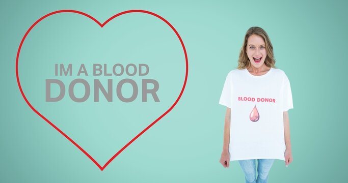 Im a blood donor text in red heart shape by smiling woman showing tshirt on blue background