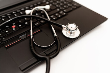 Doctor workplace with a stethoscope and laptop.Medical technology background, selective focus on doctor's stethoscope and laptop computer. online health, telemedicine concept.Close up