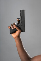 Black person showing handgun in hand