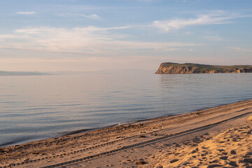 Russia, lake Baikal, island Olkhon. Sunset. Background lake. sunset on the beach