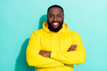 Photo of brunette cool millennial beard guy crossed arms wear yellow sports cloth isolated on teal color background