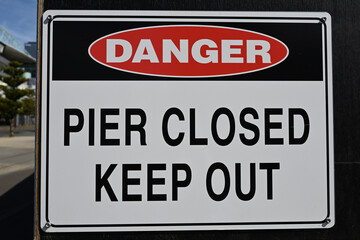 A danger sign warning people to keep out of the closed pier