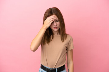Young English woman isolated on pink background with headache