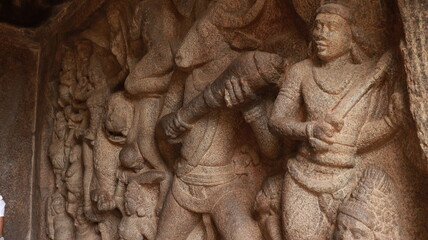 Fototapeta na wymiar Mahishasuramartini Cave Temple. Stone carvings of Mahishan and Durga fighting scene. Located in the background of the rock.A side view