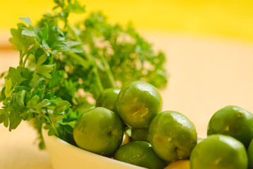 Green olives in white plate