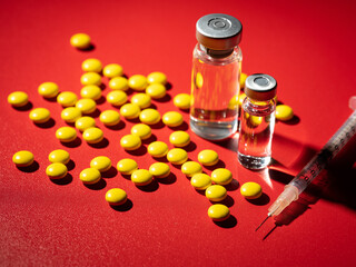 Yellow pills, syringe and drug bottle 