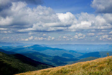 Incredibly beautiful panoramic views of the Carpathian Mountains. Peaks in the Carpathians on a background of blue sky