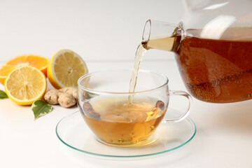 Concept of hot drink with tea on white background