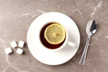 Concept of hot drink with tea on beige textured background