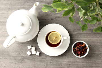 Concept of hot drink with tea on gray wooden background