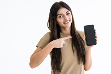 Portrait of a smiling woman showing blank smartphone screen on a white background