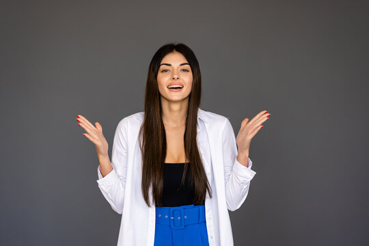 Surprised Happy Beautiful Woman Looking Sideways In Excitement Isolated On Gray Background